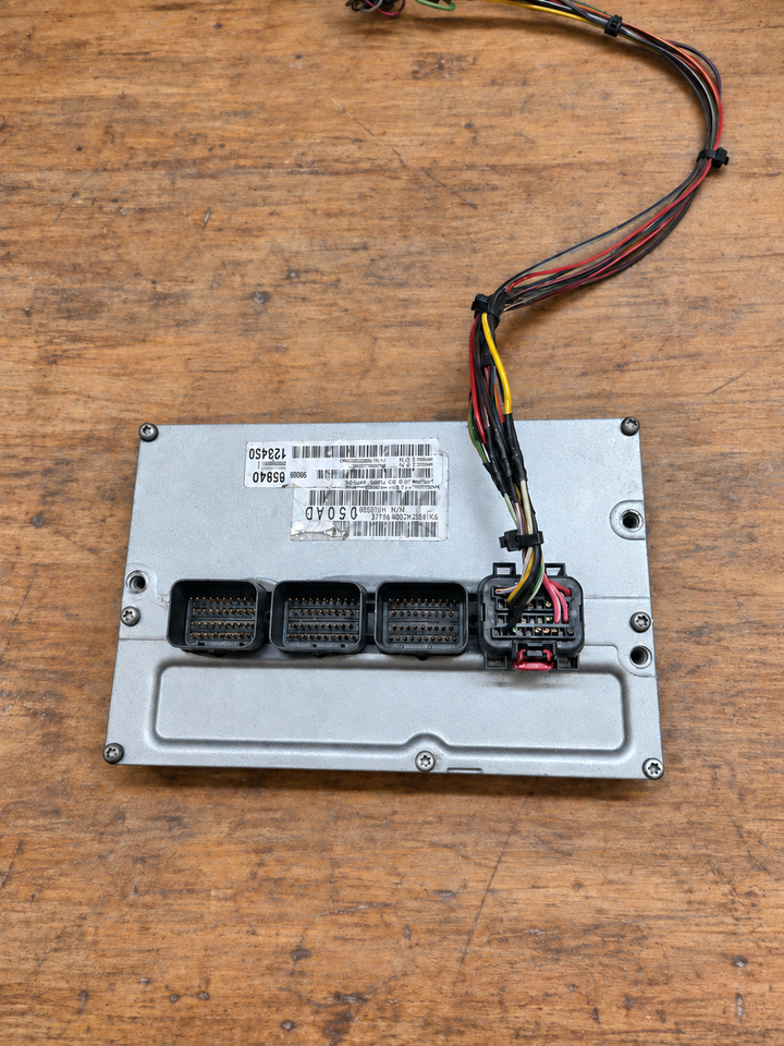 PCM connected to a programming harness at the AutoPCMS Miami lab